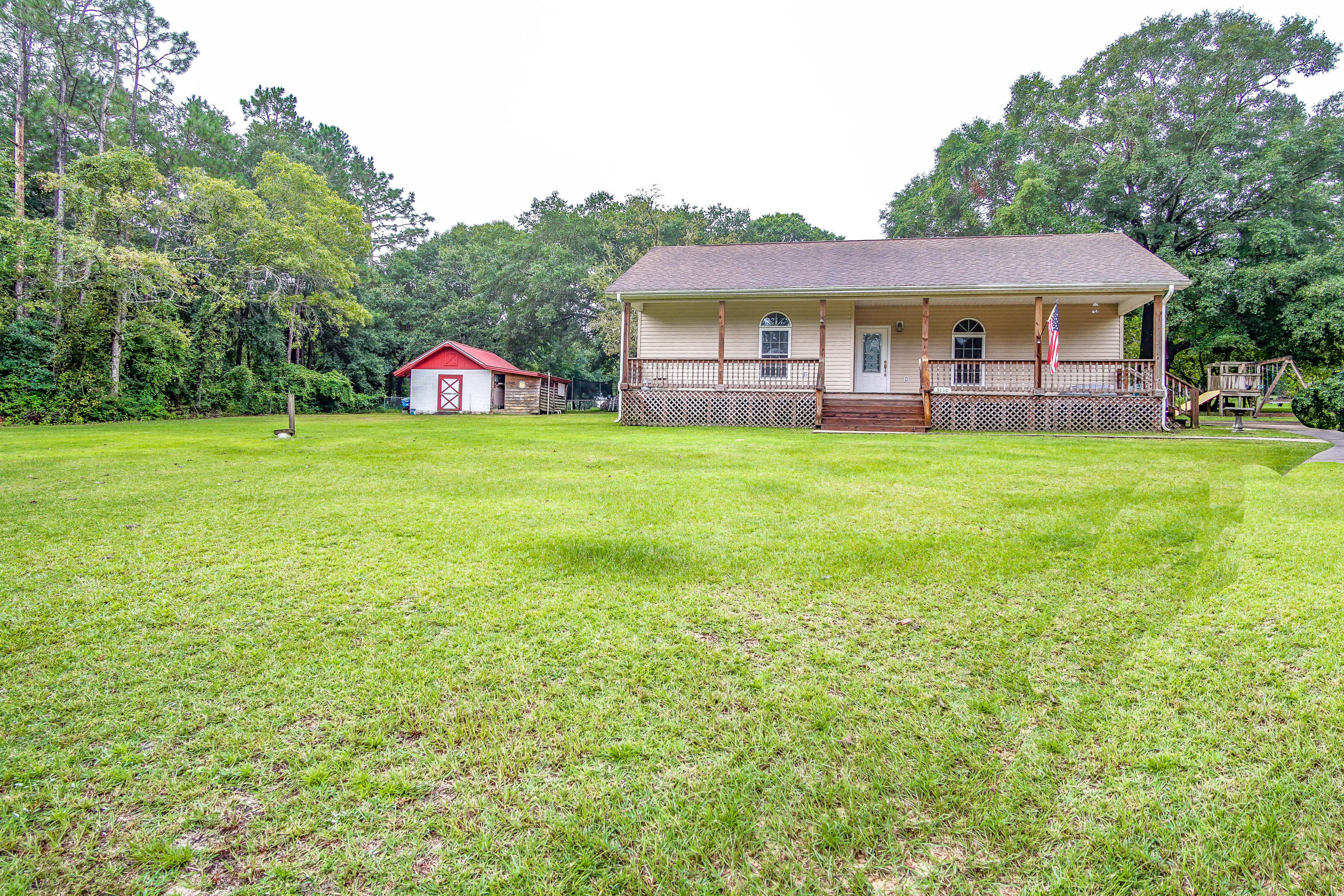3110 Bay Ridge Drive Crestview, FL 32539 - Photo 25 of 31 a front view of a house with a garden