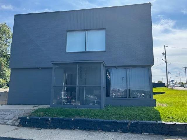 a view of a house with a yard and a garage