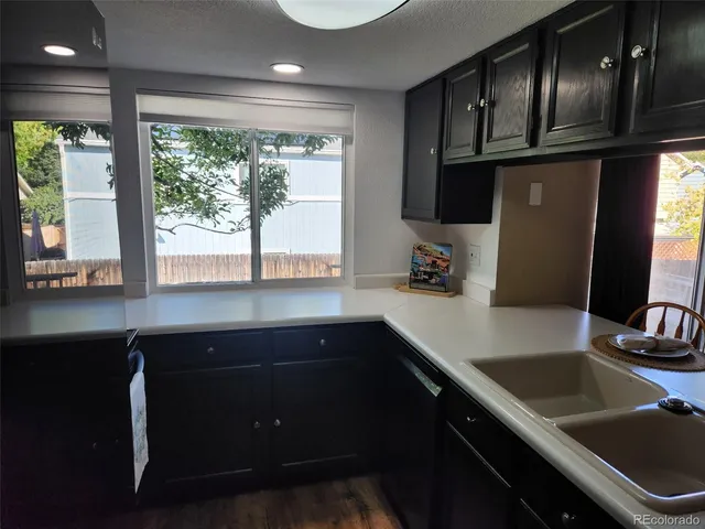a kitchen with stainless steel appliances a sink stove and cabinets
