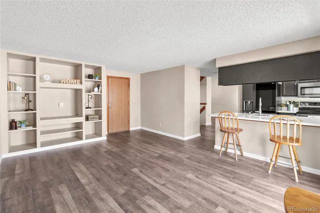 a view of kitchen with furniture and wooden floor