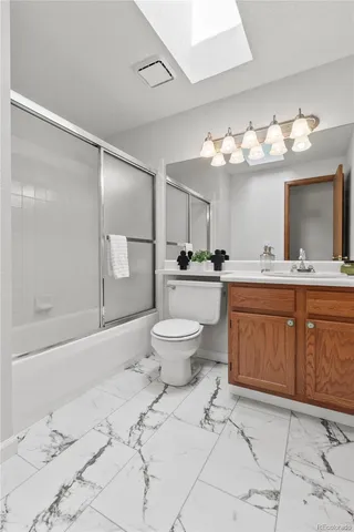 a bathroom with a sink toilet a mirror and shower