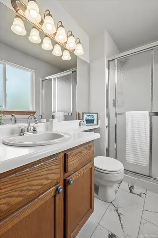 a bathroom with a sink toilet and a mirror