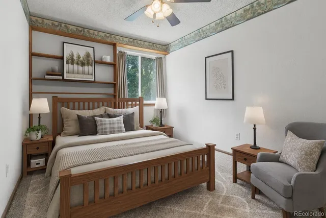 a bedroom with a bed a couch and a window