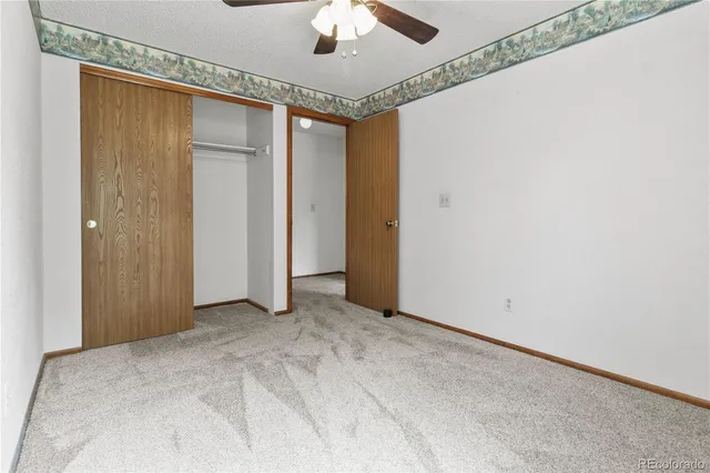 a view of a livingroom with a chandelier fan