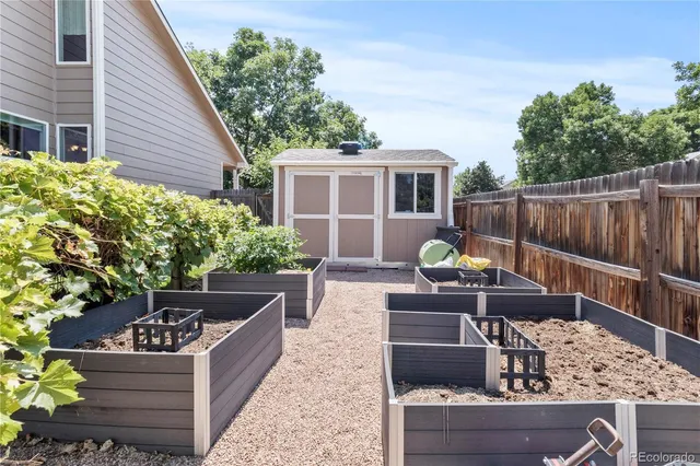 a view of a deck with couches table and chairs and potted plants