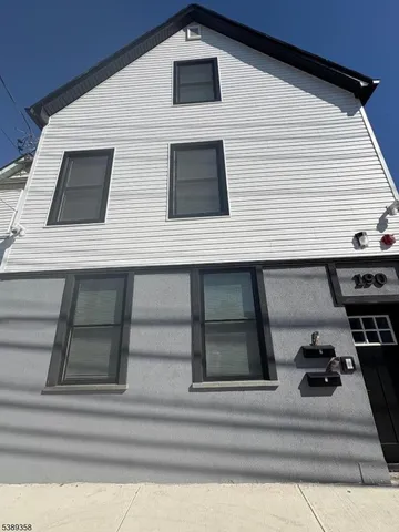 a view of a house with car parked