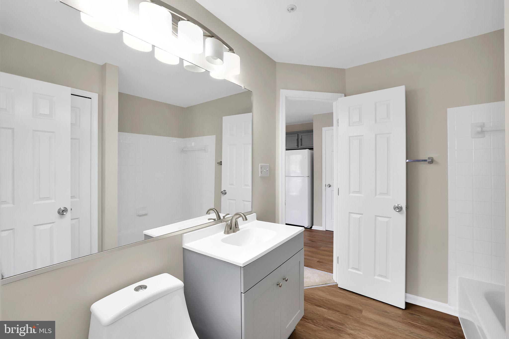 9808 Lake Pointe, Unit 201 Upper Marlboro, MD 20774 - Photo 18 of 25 a bathroom with a sink toilet and shower