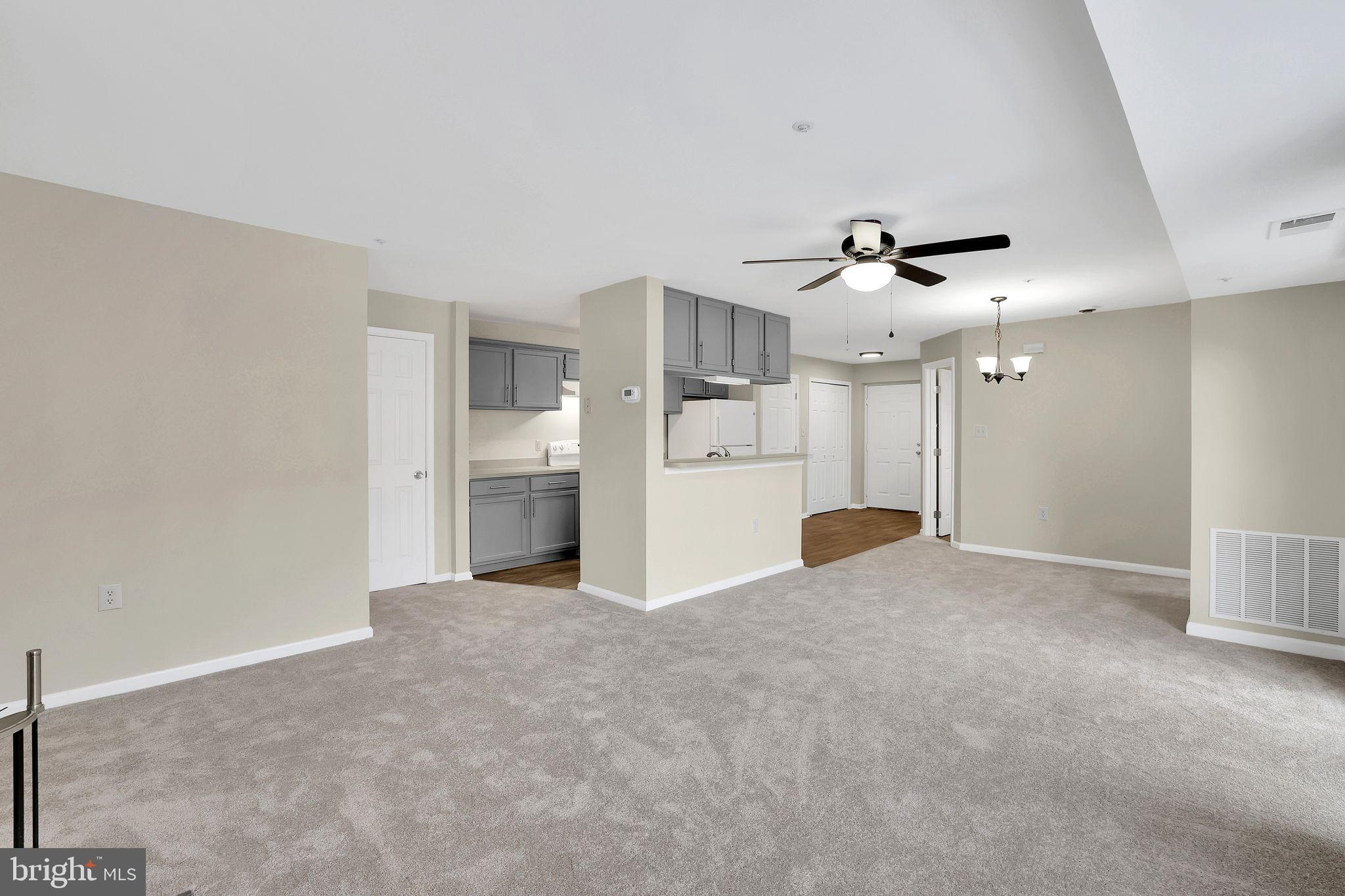 9808 Lake Pointe, Unit 201 Upper Marlboro, MD 20774 - Photo 5 of 25 a view of a kitchen with a sink and a refrigerator