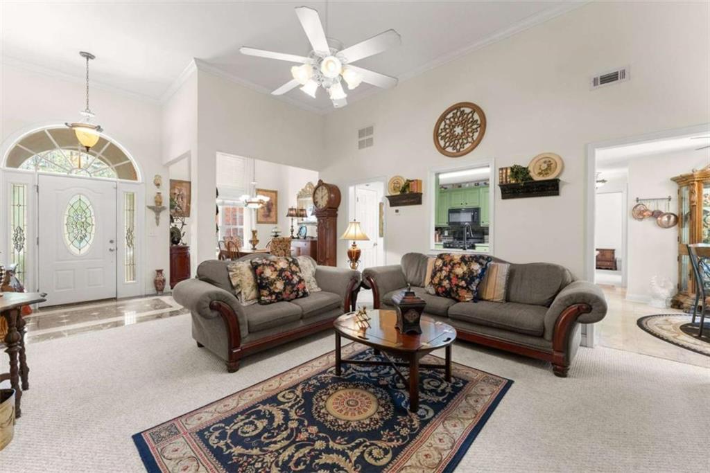 219 John Garner Road Dahlonega, GA 30533 - Photo 15 of 76 a living room with furniture a table and a clock