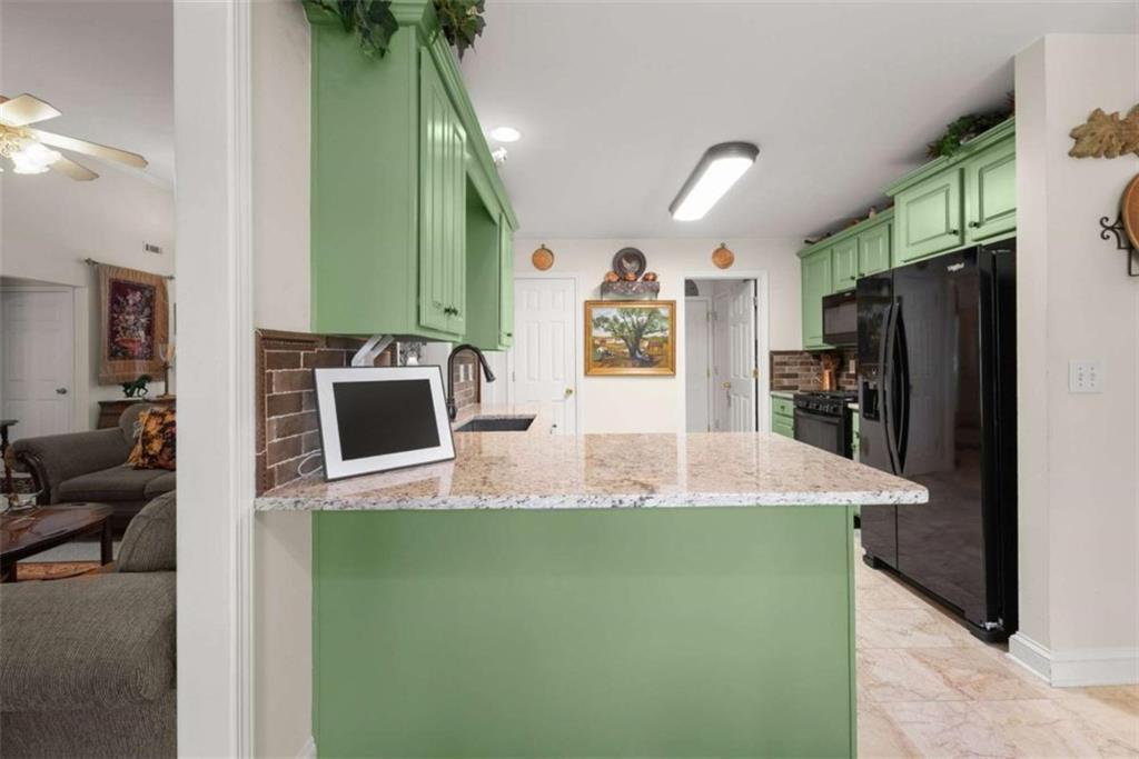 219 John Garner Road Dahlonega, GA 30533 - Photo 19 of 76 a kitchen with kitchen island a refrigerator stove and sink