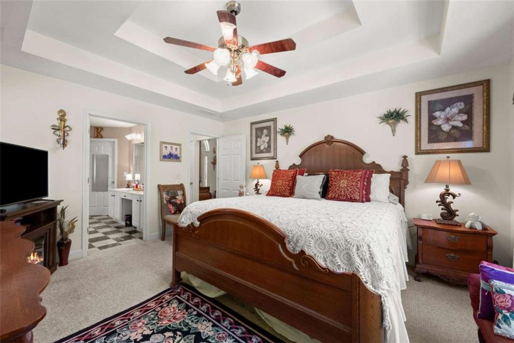 219 John Garner Road Dahlonega, GA 30533 - Photo 25 of 76 a bedroom with a bed and a flat tv screen on dresser