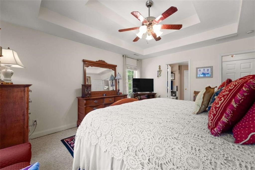 219 John Garner Road Dahlonega, GA 30533 - Photo 26 of 76 a bedroom with a bed and a flat screen tv