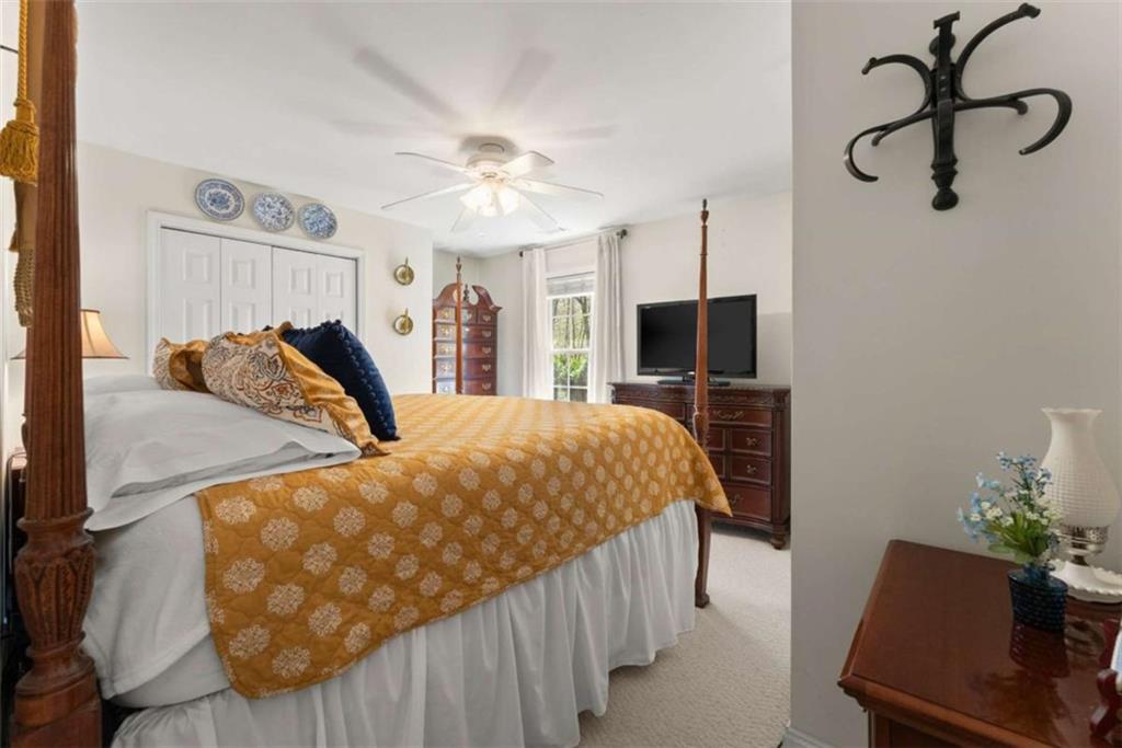 219 John Garner Road Dahlonega, GA 30533 - Photo 33 of 76 a bed room with a bed window and a chair