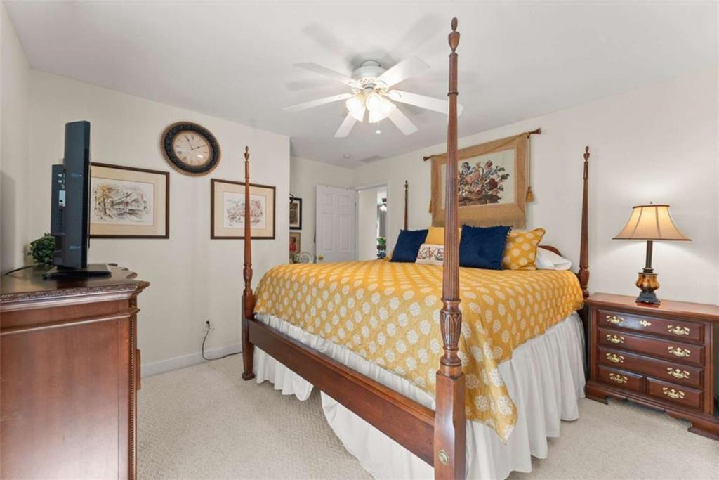 219 John Garner Road Dahlonega, GA 30533 - Photo 34 of 76 a bed room with a bed and a chandelier