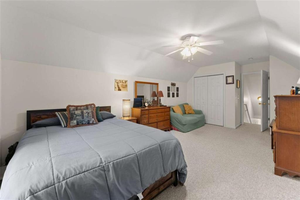 219 John Garner Road Dahlonega, GA 30533 - Photo 36 of 76 a bedroom with a bed and a chandelier