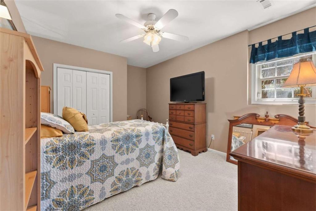 219 John Garner Road Dahlonega, GA 30533 - Photo 40 of 76 a bedroom with a bed and a flat screen tv