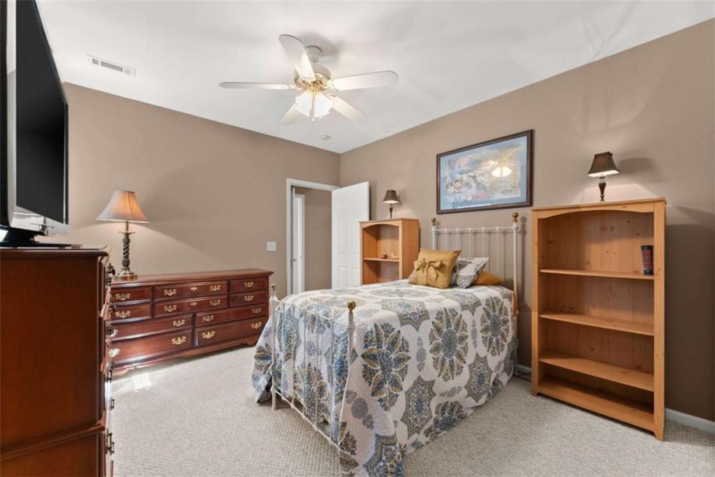 219 John Garner Road Dahlonega, GA 30533 - Photo 41 of 76 a bedroom with a bed and a chandelier