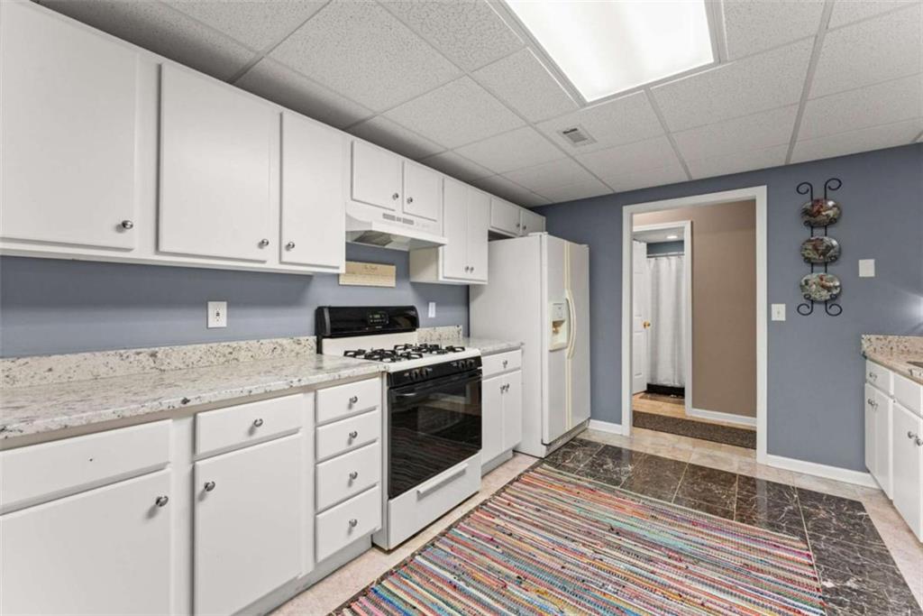 219 John Garner Road Dahlonega, GA 30533 - Photo 47 of 76 a kitchen with stainless steel appliances granite countertop a stove a sink and a refrigerator