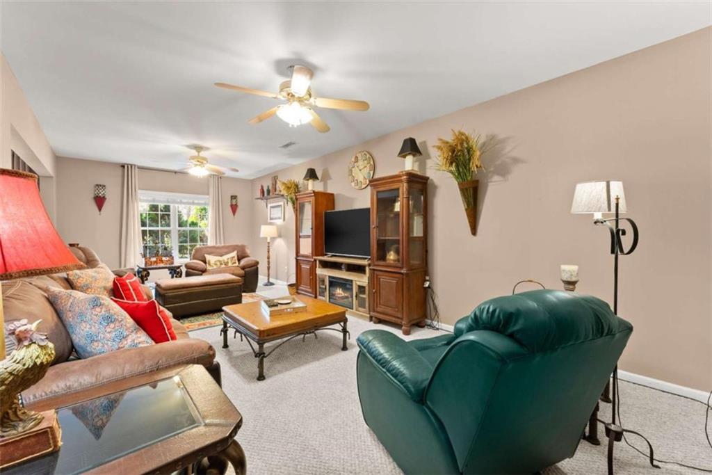 219 John Garner Road Dahlonega, GA 30533 - Photo 50 of 76 a living room with furniture and a flat screen tv