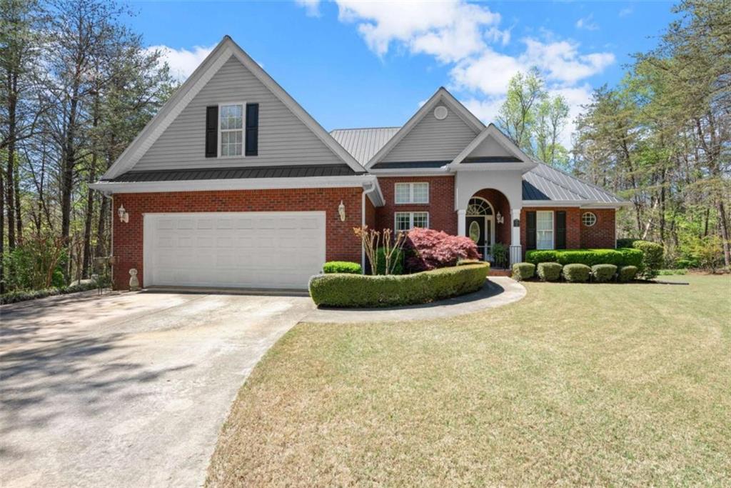 219 John Garner Road Dahlonega, GA 30533 - Photo 5 of 76 a front view of a house with a yard and garage