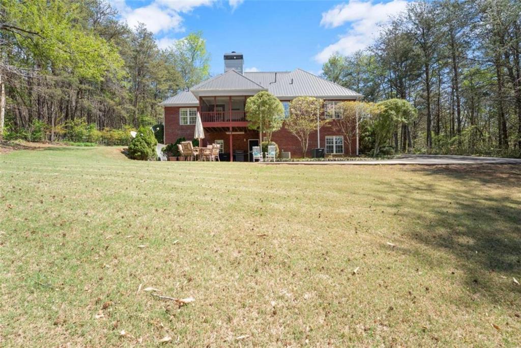 219 John Garner Road Dahlonega, GA 30533 - Photo 59 of 76 a view of a house with a yard and sitting area