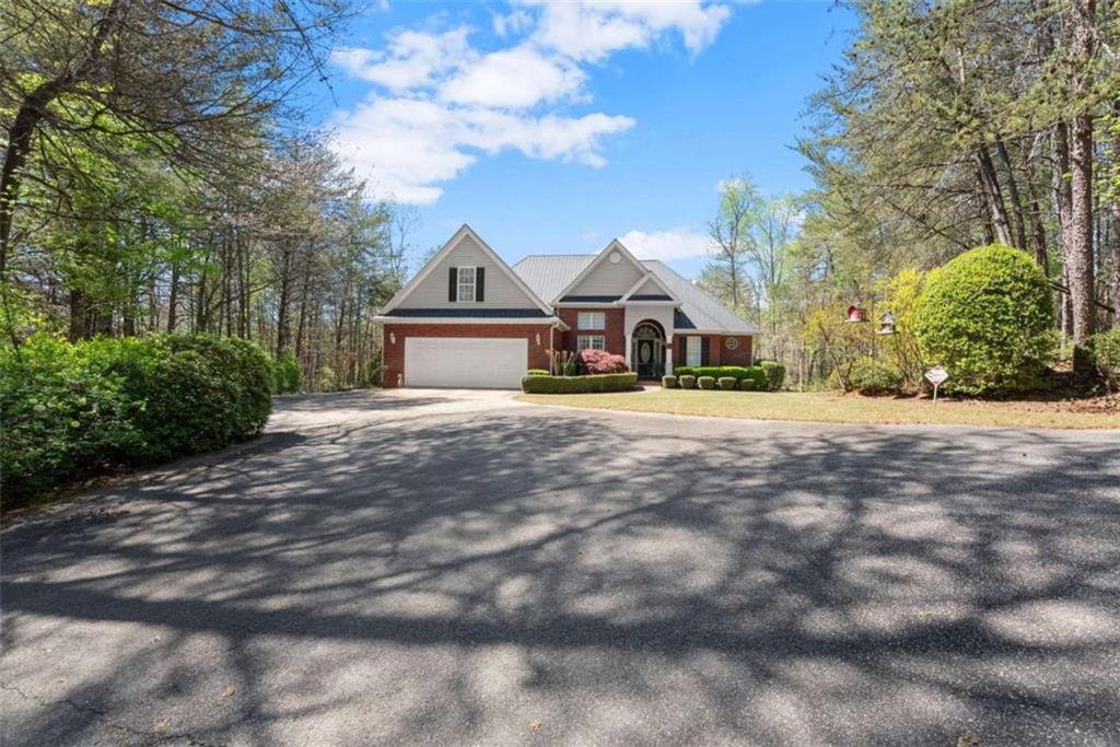 219 John Garner Road Dahlonega, GA 30533 - Photo 6 of 76 a front view of a house with a yard covered with green space