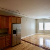 a view of kitchen with wooden floor and electronic appliances