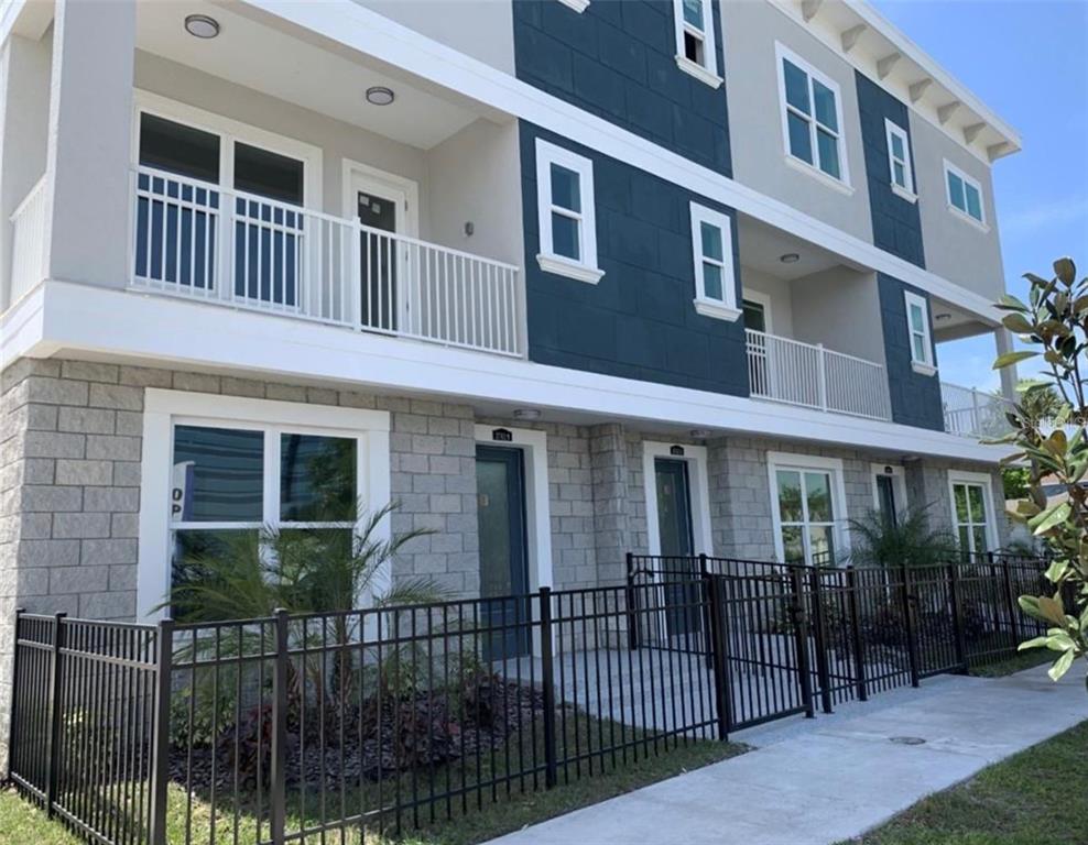3702 West Roland Street, Unit 13 Tampa, FL 33609 - Photo 2 of 10 a view of a brick building with many windows