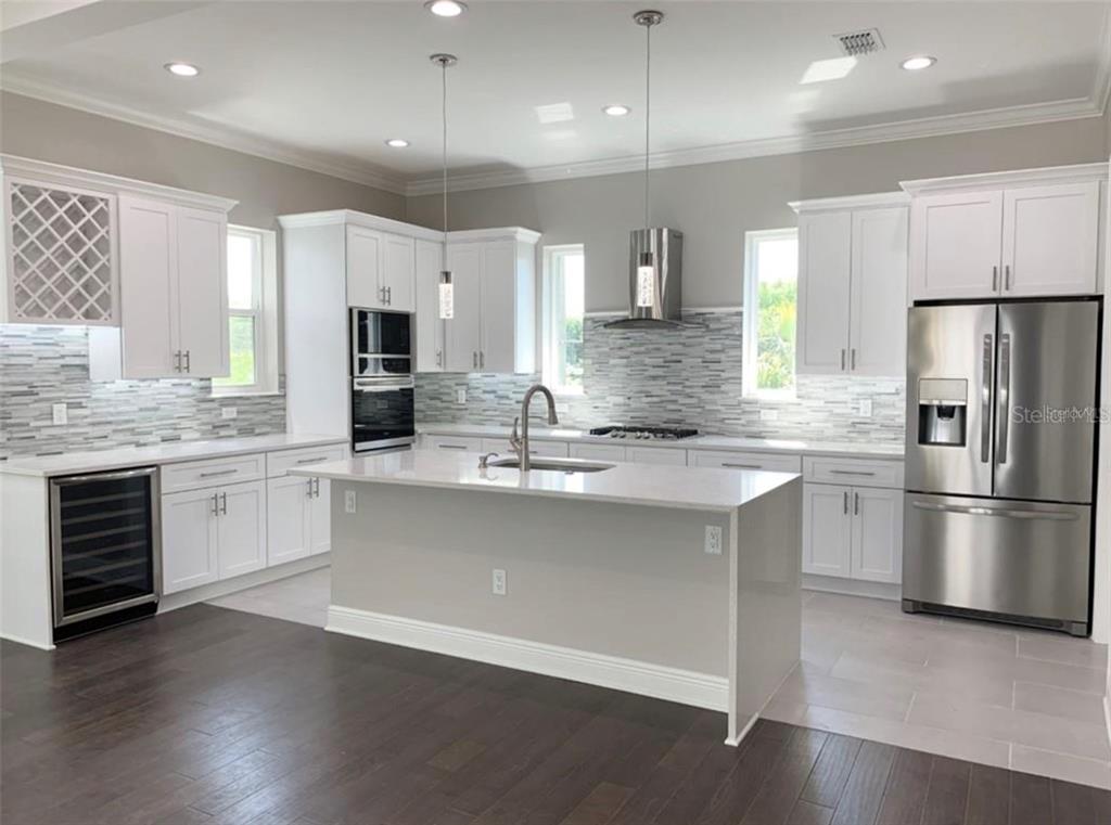3702 West Roland Street, Unit 13 Tampa, FL 33609 - Photo 6 of 10 a kitchen with a refrigerator and a stove top oven