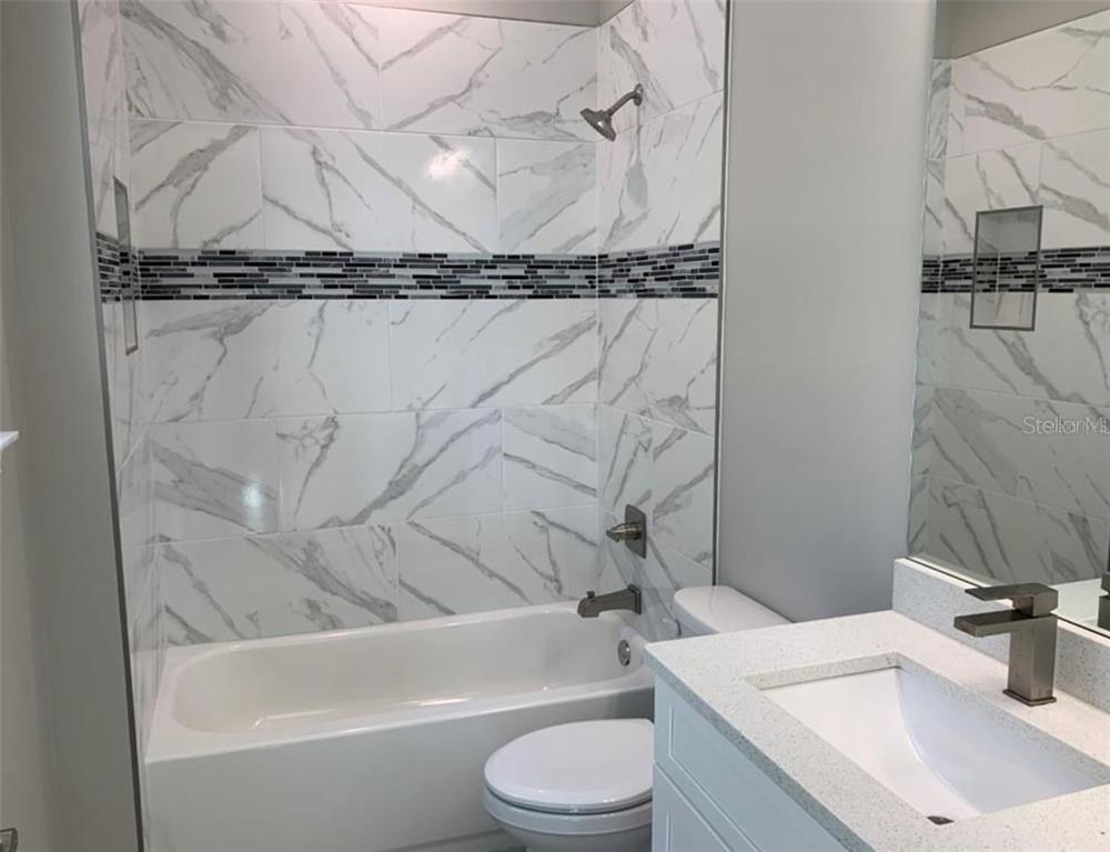 3702 West Roland Street, Unit 13 Tampa, FL 33609 - Photo 9 of 10 a bathroom with a sink toilet and shower