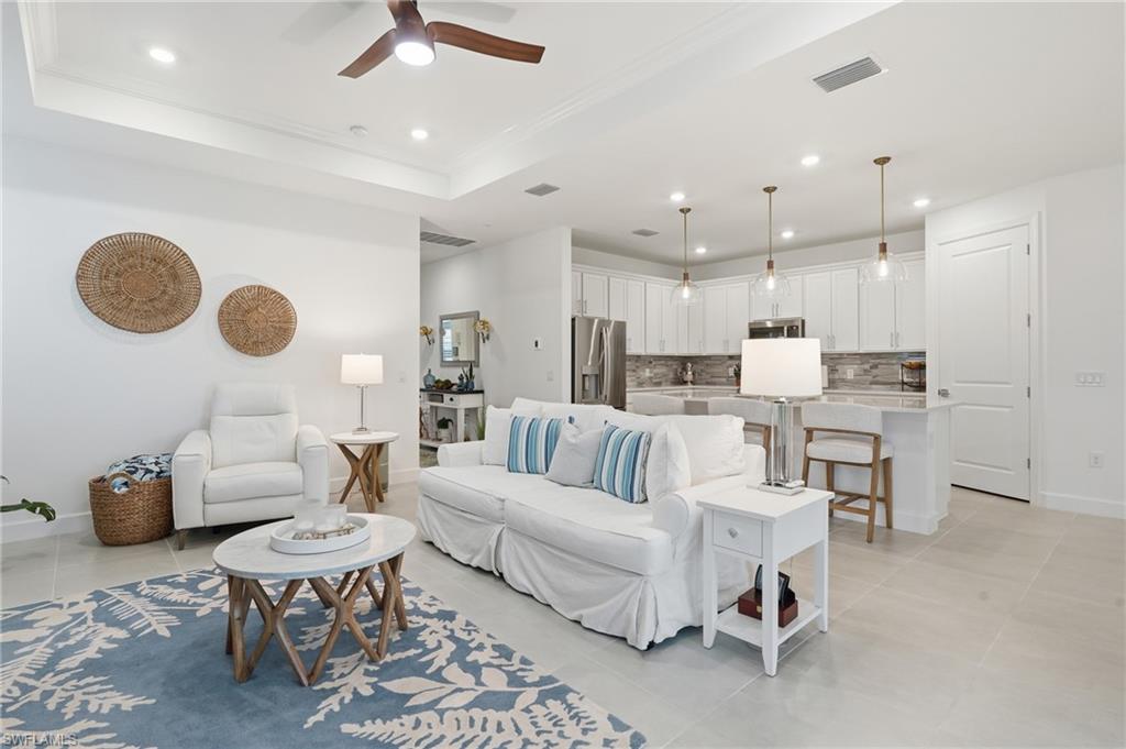 18364 Ridgeline Drive Estero, FL 33928 - Photo 3 of 50 a living room with furniture kitchen view and a chandelier