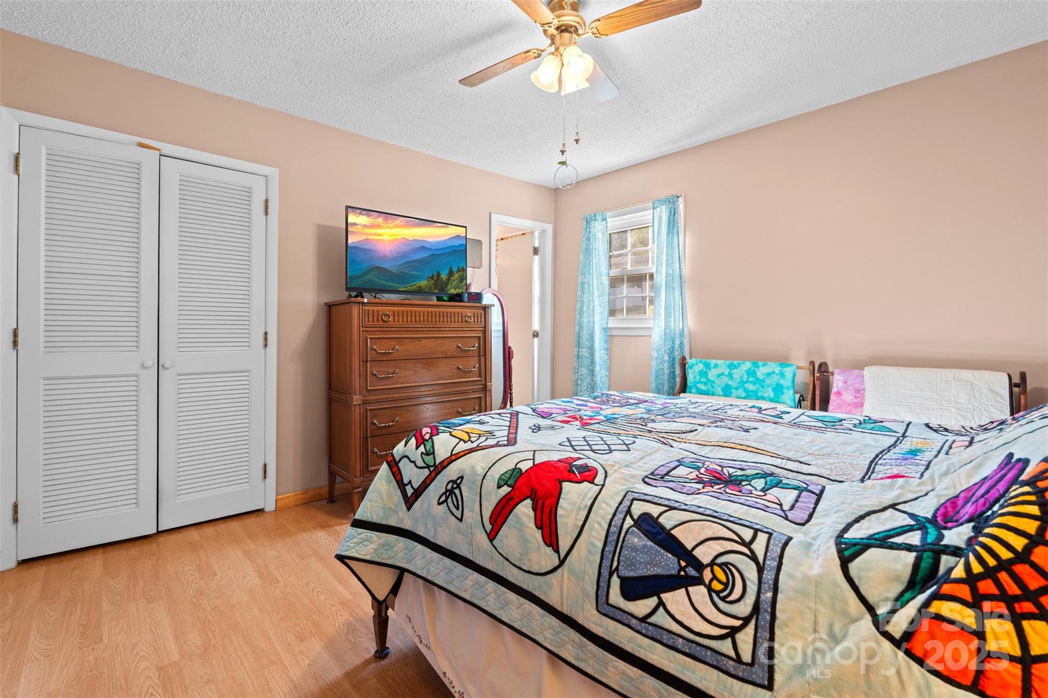 2598 Conner Circle Lenoir, NC 28645 - Photo 23 of 44 a bedroom with a bed and a chandelier