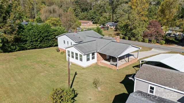 an aerial view of a house with swimming pool and garden