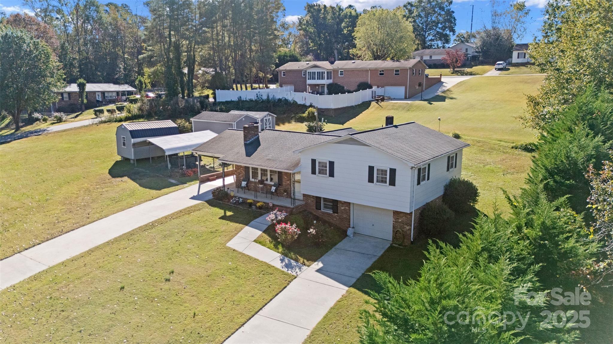 2598 Conner Circle Lenoir, NC 28645 - Photo 38 of 44 a aerial view of a house with swimming pool and large trees