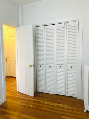 a view of a room with wooden floor and a window