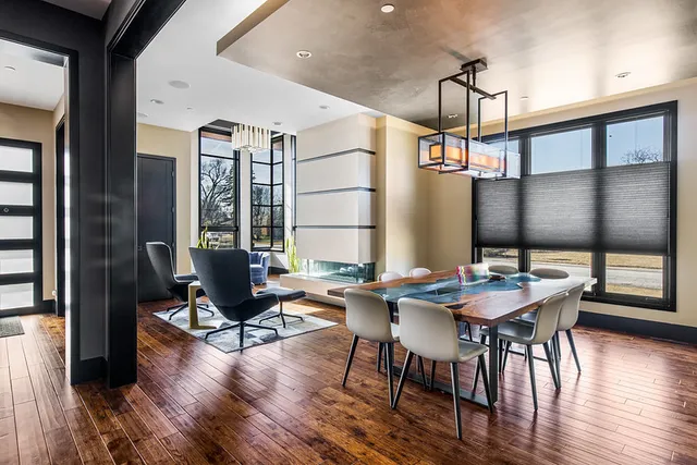 a large bedroom with a bed and a flat tv screen on dresser