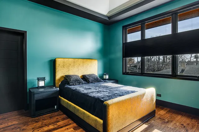 a bedroom with a large bed and a chandelier