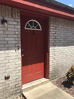 Entrance to property with brick siding