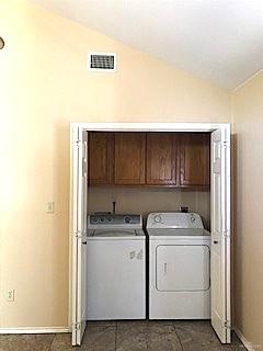 2213 West Candlelight Lane, Unit 4 Edinburg, TX 78541 - Photo 14 of 15 Laundry room featuring cabinet space and washer and clothes dryer