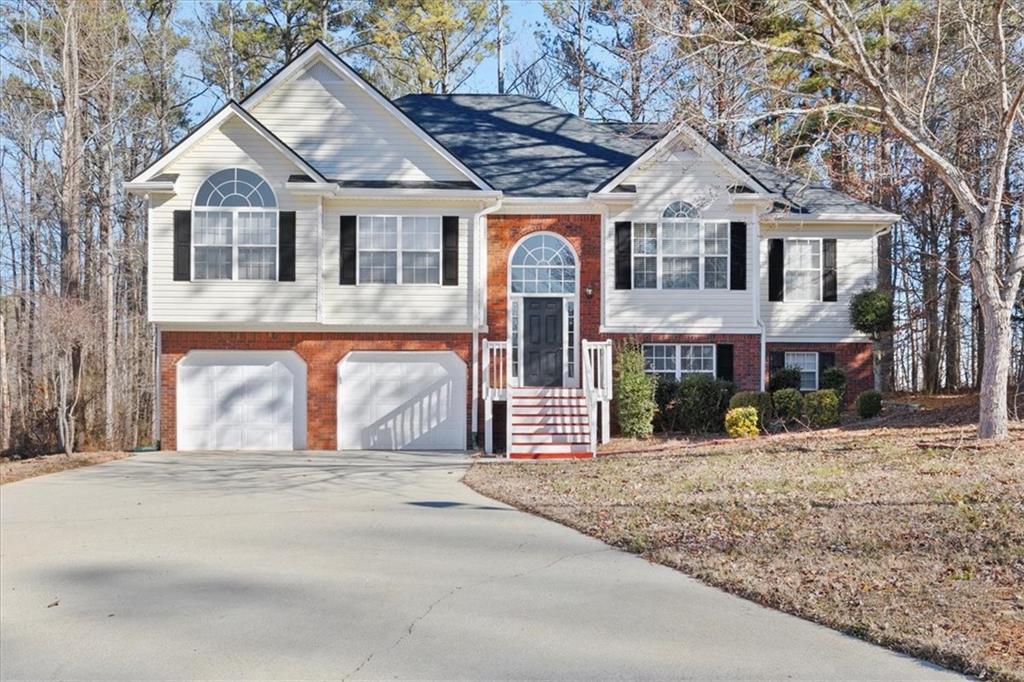 109 Enclave Court Powder Springs, GA 30127 - Photo 1 of 1 a front view of a house with a yard covered in snow
