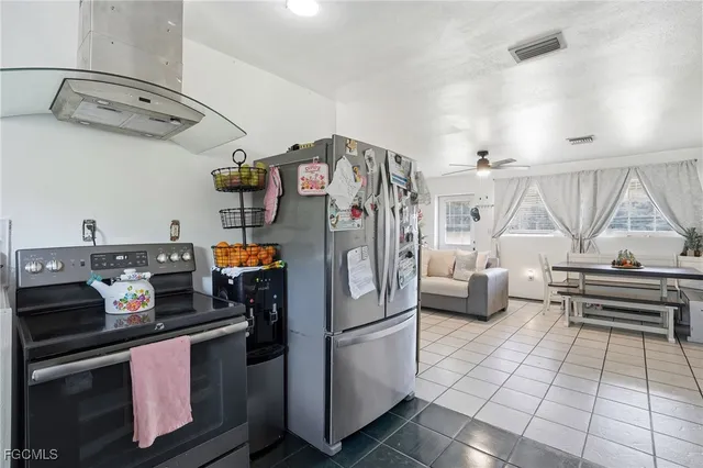 a kitchen with stainless steel appliances granite countertop a refrigerator and a stove