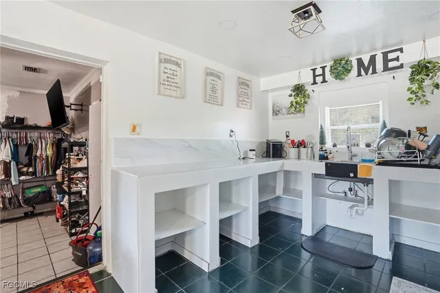 a room with furniture a rug and white walls