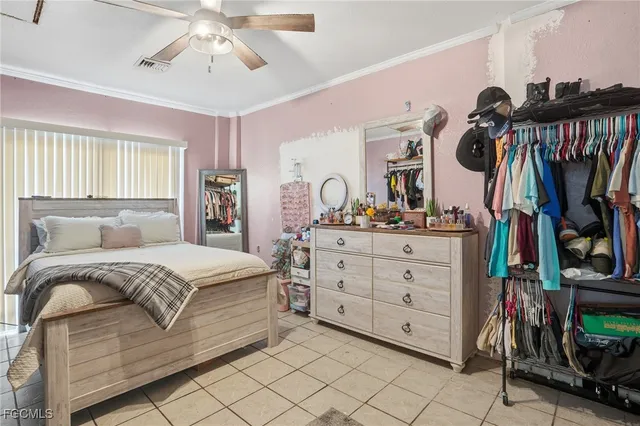 a bedroom with a bed a mirror and dresser