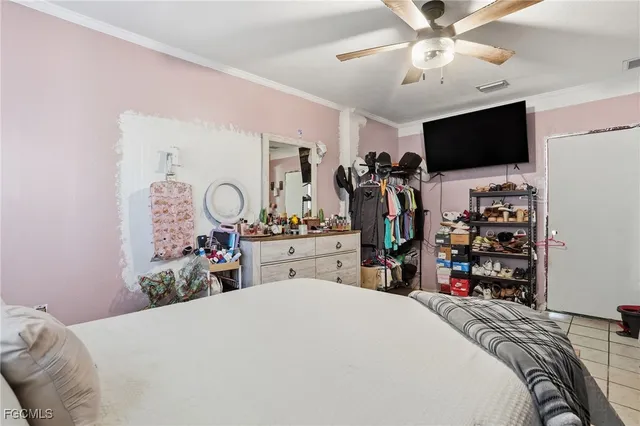 a bed room with a bed and a flat tv screen