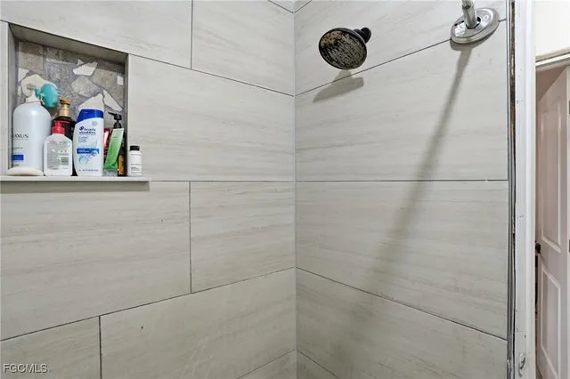 a bathroom with a painting on the wall and shower