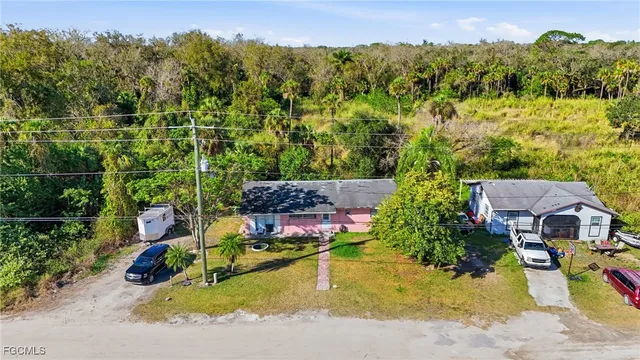 an aerial view of a house with a yard and lake view