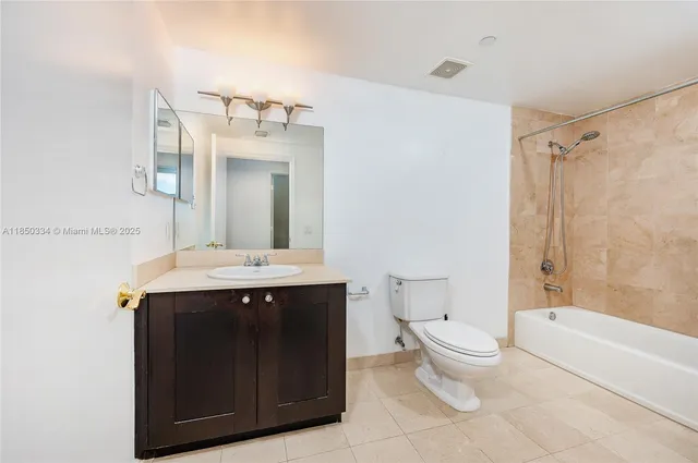 a bathroom with a sink toilet mirror and bathtub