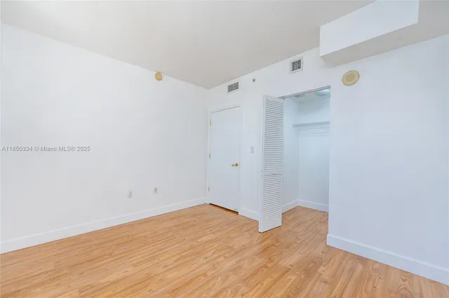 a view of room with wooden floor
