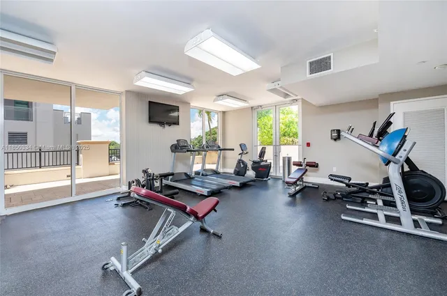 a room with gym equipment and windows