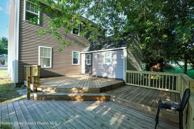 a view of a deck with chairs and wooden floor